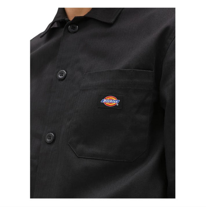 Black button-down men's shirt in cotton, with three patch pockets on the front, one inside pocket and hidden snap closure on the cuffs.